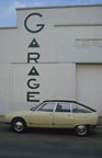 Citro�n GS Pallas poses before an art d�co garage facade. (46kb)